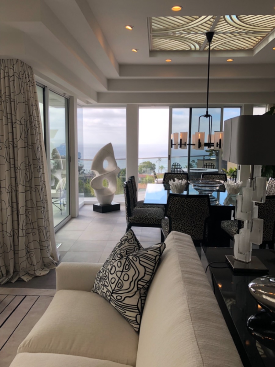 Modern oceanview living room with sculptural decor and graphic black and white patterned pillows